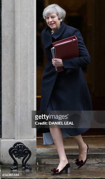 British Prime Minister Theresa May leaves 10 Downing Street in central London on March 22 to attend the weekly Prime Minister's Questions at the...