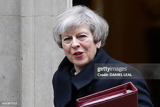 British Prime Minister Theresa May leaves 10 Downing Street in central London on March 22 to attend the weekly Prime Minister's Questions at the...