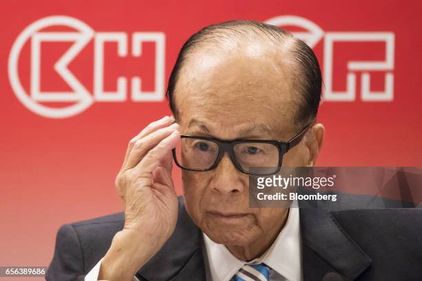 Billionaire Li Ka-shing, chairman of CK Hutchison Holdings Ltd. And Cheung Kong Property Holdings Ltd., adjusts his glasses during a news conference...