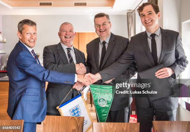 Martin Glenn , FA Chairman Greg Clarke, DFB president Reinhard Grindel and DFB general secretary Friedrich Curtius pose after signing a memorandum of...