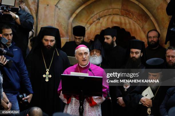Papal Nuncio Archbishop Giuseppe Lazzarotto talks during the renovation completion ceremony next to the Edicule surrounding the Tomb of Jesus at the...