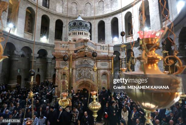Christian clergymen and other guests attend a ceremony next to the Edicule at the Church of the Holy Sepulchre, traditionally believed to be the...