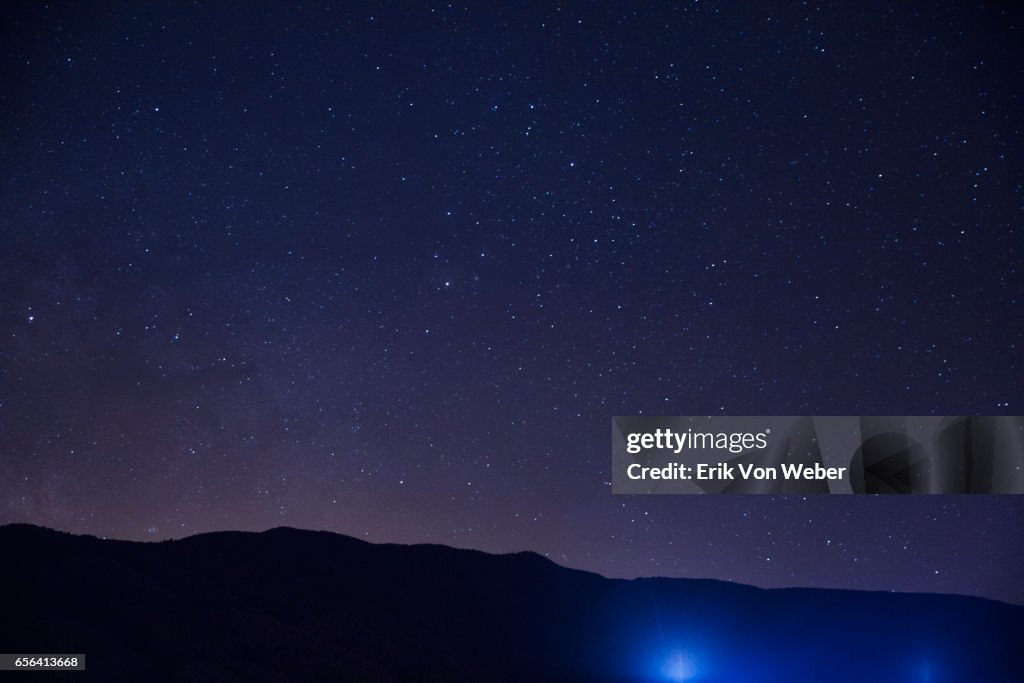 Hillside at night with stars