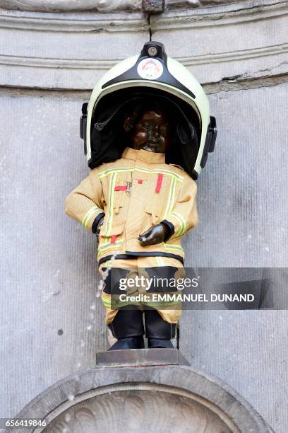 Brussels' most famous landmark -- the Manneken Pis statue of a little boy -- is dressed up in a fireman's outfit to hail the efforts of rescue...