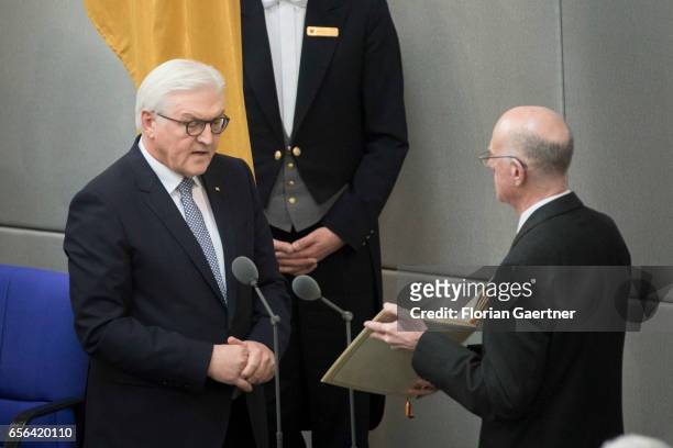 German new president Frank-Walter Steinmeier speaks as President of the Bundestag Norbert Lammert holds the German Constitution during his...