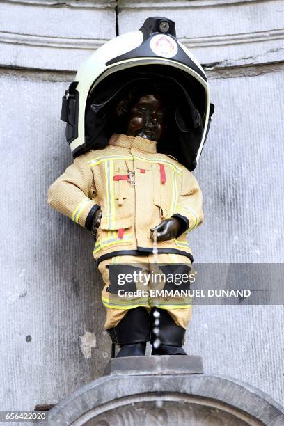 Brussels' most famous landmark -- the Manneken Pis statue of a little boy -- is dressed up in a fireman's outfit to hail the efforts of rescue...