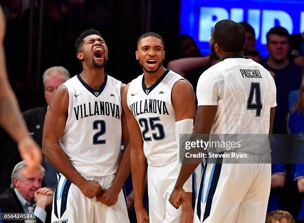 Kris Jenkins, Mikal Bridges and Eric Paschall of the Villanova Wildcats celebrate the play against the Creighton Bluejays during the Big East...