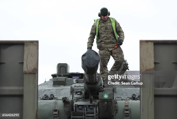 British Army tank driver descends from a Challenger 2 tank of the 5th Battalion The Rifles after the tank and other heavy vehicles arrived by ship on...