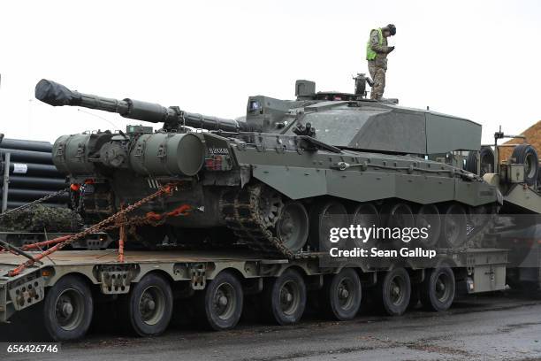 British Army tank driver descends from a Challenger 2 tank of the 5th Battalion The Rifles after the tank and other heavy vehicles arrived by ship on...