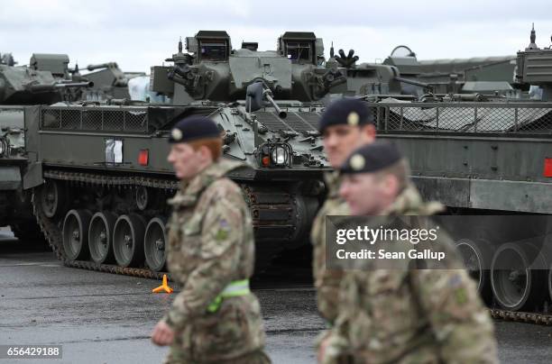 British Army soldiers walks past Warrior tanks of the 5th Battalion The Rifles after the tanks and other heavy vehicles arrived by ship on March 22,...