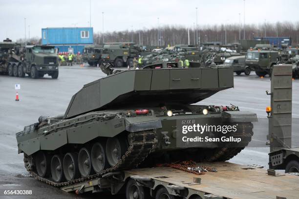 British Army Challenger 2 tank of the 5th Battalion The Rifles drives backwards onto a truck trailer for transport after the tank and other heavy...