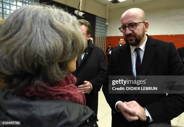 Belgian Prime Minister Charles Michel meets with people during a minute of silence at 09:11 am in the Maebelle - Maalbeek subway station on the first...