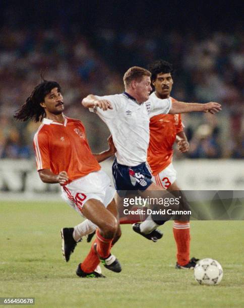 Paul Gascoigne of England holds off the challenges of Ruud Gullit and Frank Rijkaard of the Netherlands during the FIFA World Cup Finals 1990 group...