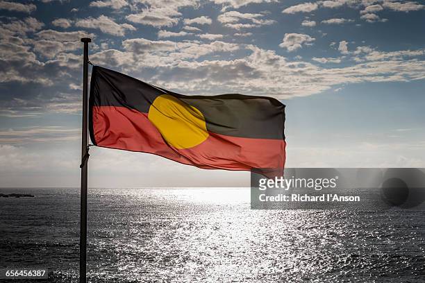 aboriginal flag at bondi beach - aboriginal flag stock-fotos und bilder