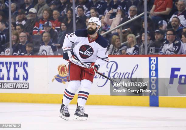 Mark Stuart of the Winnipeg Jets keeps an eye on the play during first period action against the Minnesota Wild at the MTS Centre on March 19, 2017...