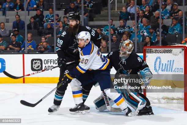 Brent Burns and Aaron Dell of the San Jose Sharks defend the net against Alexander Steen of the St. Louis Blues at SAP Center on March 16, 2017 in...