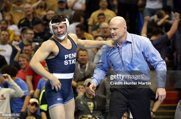 Vincenzo Joseph of the Penn State Nittany Lions celebrates with head coach Cael Sanderson after winning the 165 pound title during the championship...