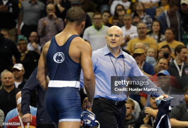 Head coach Cael Sanderson of the Penn State Nittany Lions reacts after Mark Hall wins the 174 pound title during the championship finals of the NCAA...
