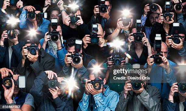 paparazzi photographers in action - blitzlichtgewitter stock-fotos und bilder