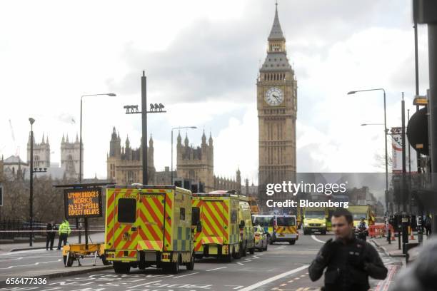 Ambulances stand with other emergency service vehicles on Westminster Bridge, beside the Houses of Parliament and the Elizabeth Tower, commonly...