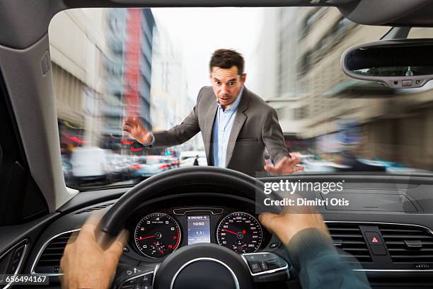 man about to be knocked over by speeding car - guy looking down stock pictures, royalty-free photos & images