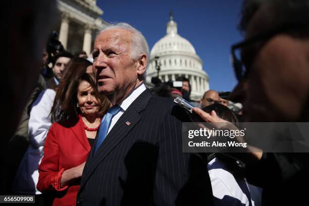 Former U.S. Vice President Joseph Biden speaks to members of the media as House Minority Leader Rep. Nancy Pelosi looks on after an event on health...