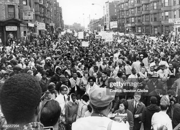 Dr. Martin Luther King Jr. Leads the mile-long column of marchers walking from Roxbury to Boston Common on Apr. 23, 1965. The march left the Carter...