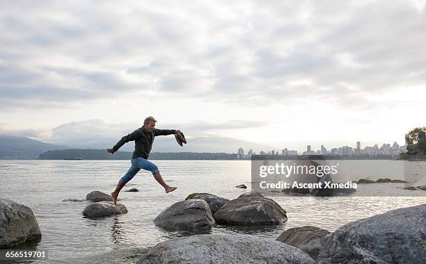 Leap Over Rocks 11,227 Jumping Between Rocks Stock Photos, High-Res Pictures, and ...