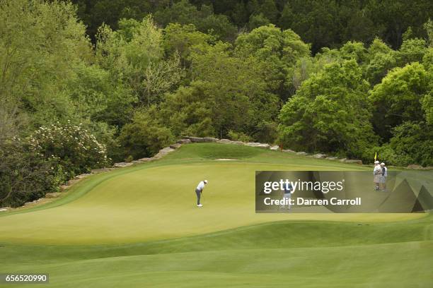 Rory McIlroy of Northern Ireland putts on the 2nd hole of his match against Soren Kjeldsen of Denmark during round one of the World Golf...