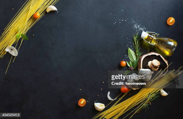 assorted italian food recipe ingredients on black background. - rustic plate overhead photos et images de collection