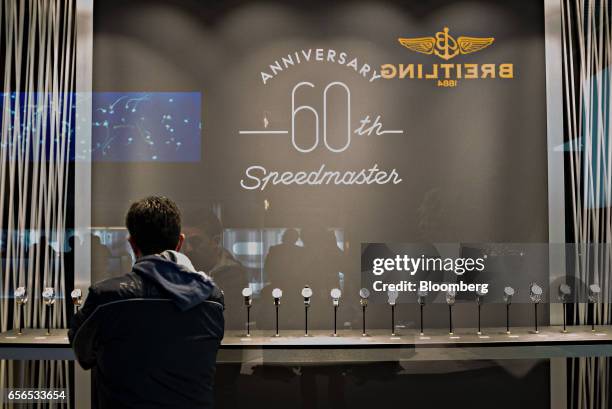 Visitor browses a display of Speedmaster luxury wristwatches, produced by Omega SA, a unit of Swatch Group AG, during the 2017 Baselworld luxury...