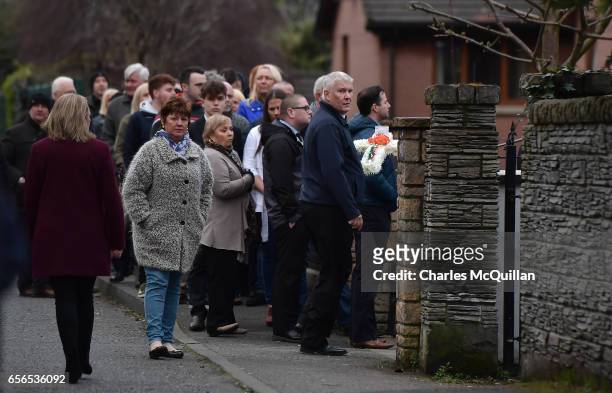 Steward carries flowers as mourners pay ther respects at the home of Martin McGuinness on March 22, 2017 in Londonderry, Northern Ireland. Northern...