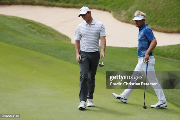 Rory McIlroy of Northern Ireland reacts after missing a putt on the 17th green in his match against Soren Kjeldsen of Denmark during round one of the...