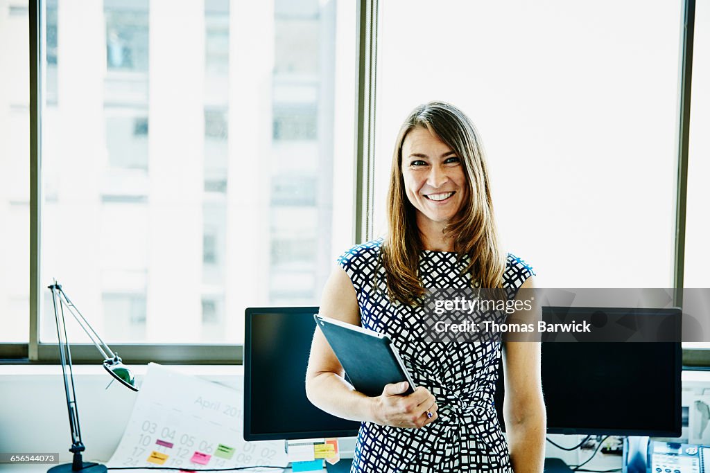 Businesswoman holding digital tablet in office