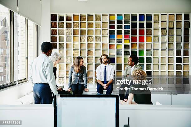 smiling group of businesspeople in discussion - cool modern mann büro business stock-fotos und bilder