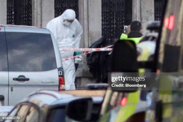 Forensic officers work near the outer perimeter fence of the Houses of Parliament in central London, U.K., on Wednesday, March 22, 2017. Multiple...