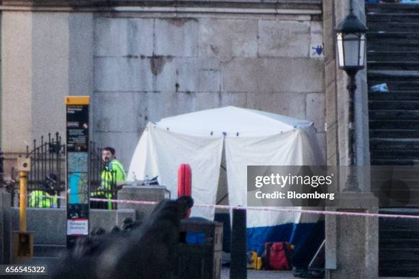 Police tent stands on the Thames Path near Westminster Bridge in central London, U.K., on Wednesday, March 22, 2017. Multiple shots were fired near...