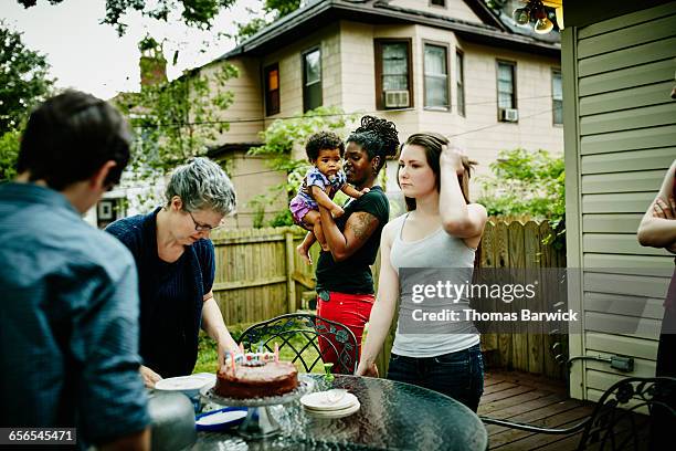 family gathered around table celebrating birthday - leaninlgbt stock pictures, royalty-free photos & images