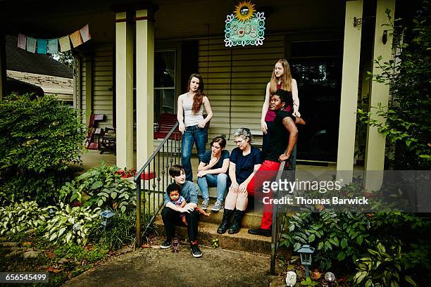 Married lesbian couple with family on front porch