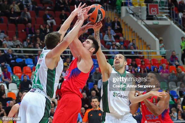 Nando De Colo of the CSKA Moscow battles for the ball against Luke Harangody and Adrien Moerman of the Darussafaka Dogus Istanbul during the...