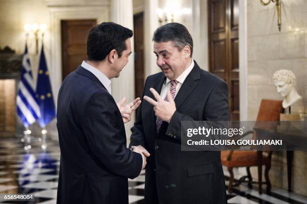 Greece's Prime Minister Alexis Tsipras greets Germany's Foreign Minister and Vice-Chancellor Sigmar Gabriel at his office in Athens, on March 22,...