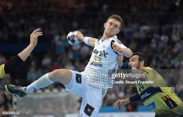 Nikola Bilyk of Kiel is challenged by Geden Guardiola of Rhein Neckar during the first leg round of 16 EHF Champions League match between THW Kiel...