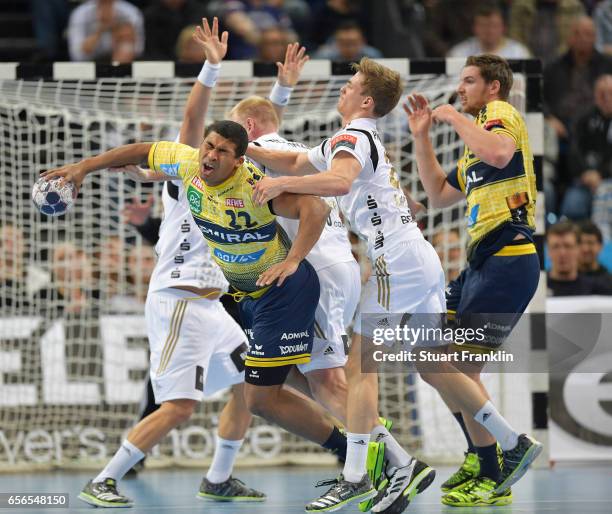 Rune Dahmke of Kiel is challenged by Mads Mensah Larsen of Rhein Neckar during the first leg round of 16 EHF Champions League match between THW Kiel...