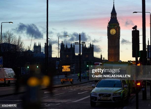 Emergency services' vehicles are pictured on Westminster Bridge, adjacent to the Houses of Parliament in Westminster, central London on March 22 in...