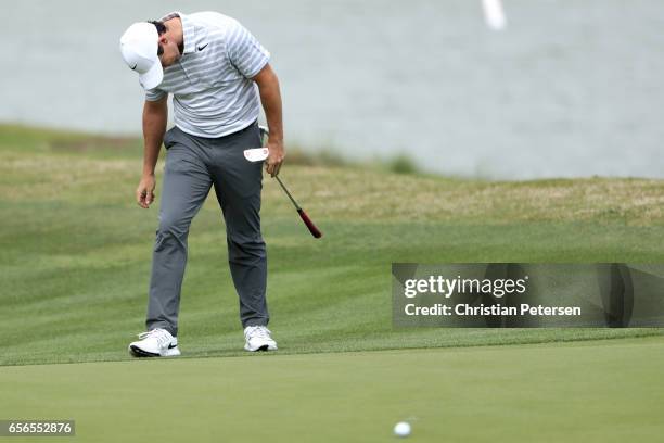 Rory McIlroy of Northern Ireland reacts after missing a putt on the 14th hole of his match during round one of the World Golf Championships-Dell...