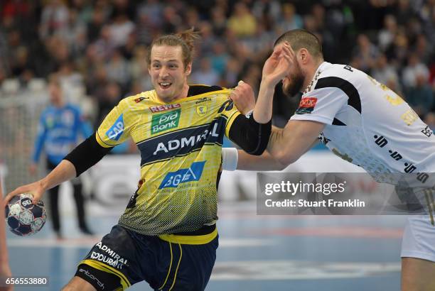 Ilija Brozovic of Kiel challenges Kim Ekdahl Du Rietz of Rhein Neckar during the first leg round of 16 EHF Champions League match between THW Kiel...