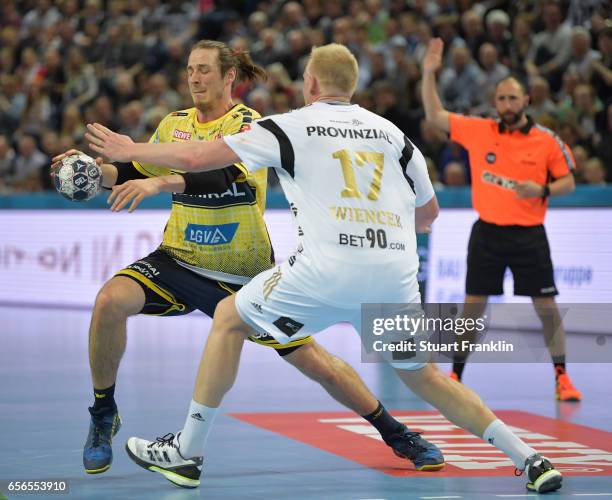 Patrick Wiencek of Kiel challenges Kim Ekdahl Du Rietz of Rhein Neckar during the first leg round of 16 EHF Champions League match between THW Kiel...