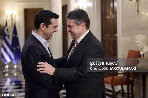 Greece's Prime Minister Alexis Tsipras greets Germany's Foreign Minister and Vice-Chancellor Sigmar Gabriel at his office in Athens, on March 22,...