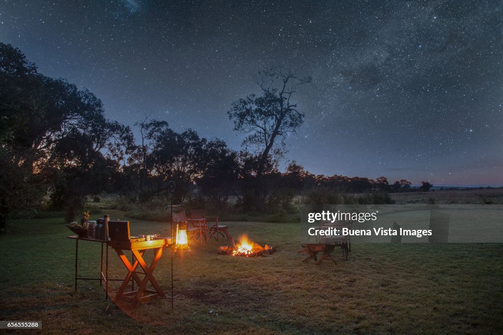 A safari camp at night under starry sky