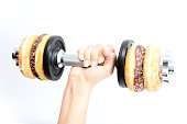 Healthy lifestyle concept suggested by weightlifting doughnuts
